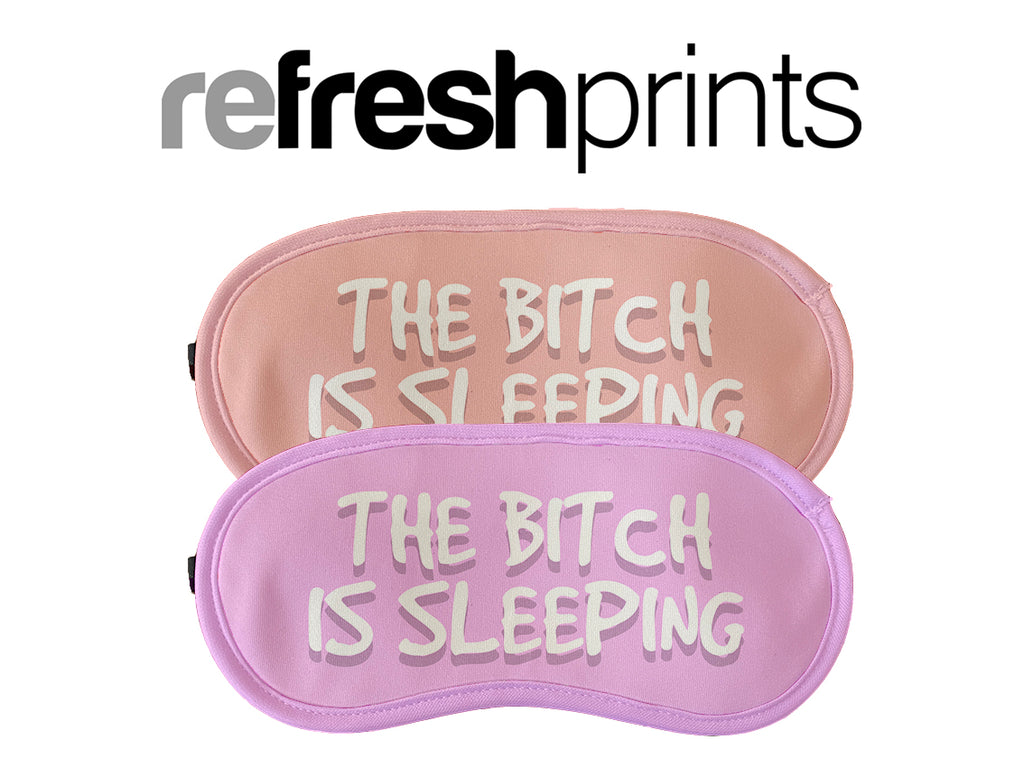 Pink and peach coloured sleeping masks with humorous text 'The bitch is sleeping.' for a stylish and comfortable sleep accessory.